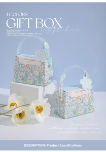 Close-up of elegant wedding candy boxes with floral tulip prints and clear chain handles