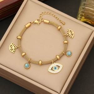 Gold evil eye bracelet with turquoise beads and sparkling crystal pendants on a box