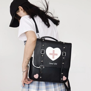Close-up of black JK Lolita backpack with white heart patch and Sweet Girl embroidery