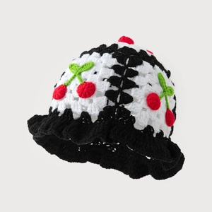 Handmade crochet bucket hat with red cherry detail and scalloped ruffle edge
