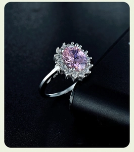 Macro shot of 925 silver ring featuring pink oval stone and halo of fine diamonds