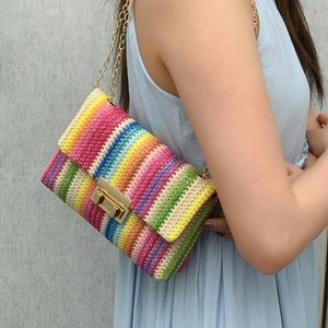 Vibrant rainbow woven shoulder bag with gold chain strap and lock closure for summer