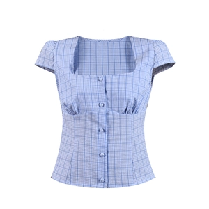 Detail of blue gingham short sleeve shirt with square neck and fabric-covered buttons