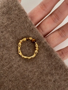 Detail of 18K gold plated tiger eye stone ring featuring hand-hammered texture and beads