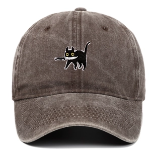 Detailed embroidery of a black cat holding a knife on a vintage washed cotton baseball cap