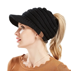 Women's black knit ponytail beanie with CC leather patch and brim for outdoor warmth