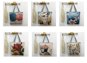 Detailed view of canvas tote bags with various floral prints and striped handles