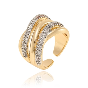 Macro view of gold multi-layer cross ring with pavé cubic zirconia on white background