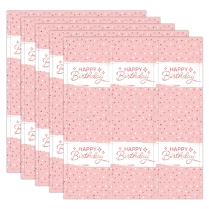 Macro shot of pink and rose gold polka dot candy bar wrappers for baby shower party favors