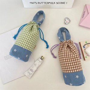 Close-up of thick canvas drawstring water bottle bags with plaid patchwork and stars