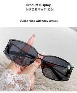 Detailed close-up of futuristic Y2K black frame sunglasses with dark grey lenses
