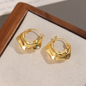 Detailed view of 18K gold plated V-shaped pleated hoop earrings with wavy texture