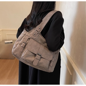 Detail of vintage grey-brown large PU leather tote bag with double front buckle pockets