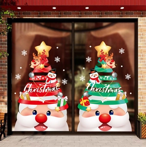 Detailed view of Merry Christmas window stickers with Santa and stars on a glass door