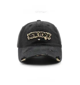 Detail of distressed baseball cap with New York 1989 embroidery and ripped texture