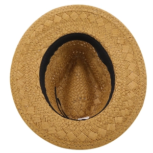 Detail view of woven straw sun hat showing inner sweatband and crisscross texture