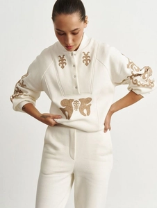 Women's cream two-piece lounge set featuring embroidered quarter-button sweatshirt and pants