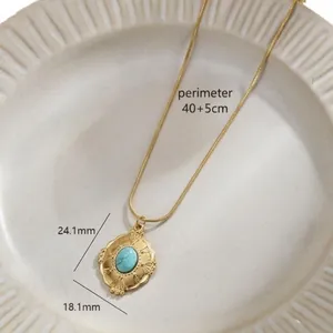 Titanium steel necklace with oval turquoise pendant and embossed gold setting