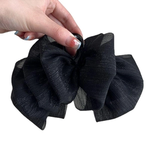 Large black mesh bow hair claw clip made of pleated fabric layers for thick hair styling