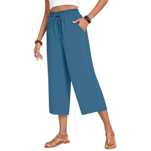 Detail of blue linen wide-leg pants featuring textured fabric and adjustable drawstring waist