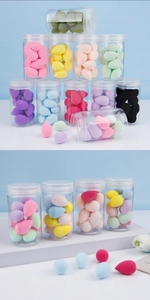Detailed view of colorful teardrop makeup sponges in clear jars with a floral background