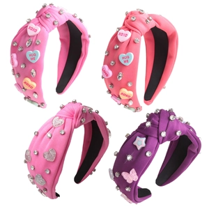 Set of four knotted fabric headbands in pink and purple with pearls and rhinestones