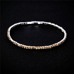 Macro shot of 2.0mm elastic bridal bracelet with shimmering orange crystals in silver