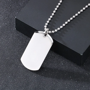 Close-up of a silver stainless steel dog tag pendant on a ball chain with gift box