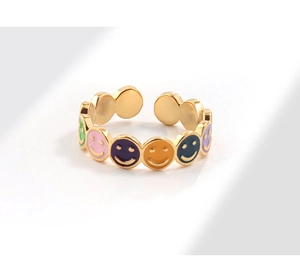 Detail of 18K gold-plated adjustable ring featuring colorful enamel smiley face charms