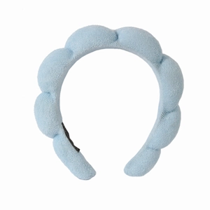 Close-up of light blue braided terry cloth headband with soft sponge texture