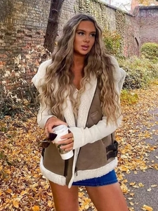 Brown faux leather and white fleece Y2K vest jacket shown on a model in a street setting