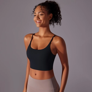Detail of black sports bra with thin straps and U-neck in seamless nylon fabric