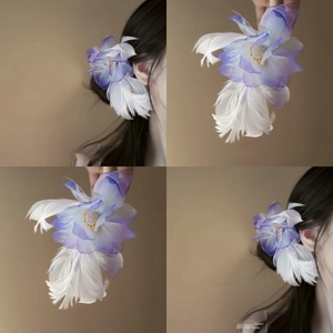 Macro detail of purple gradient fabric flower hair clip with white feathers and pearls