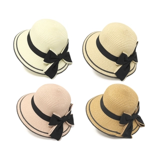 Set of four woven straw sun hats for women with elegant black ribbons and bows