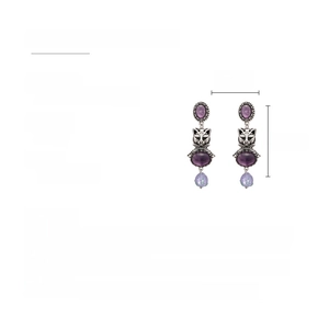 Detailed view of vintage cat drop earrings with purple crystals and resin beads