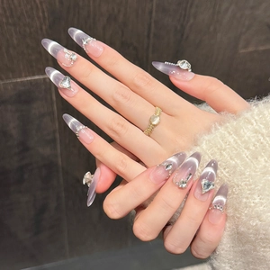 Long almond cat-eye press-on nails with lavender purple gradient and silver heart rhinestones