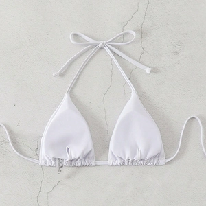 Classic white halter triangle bikini top with adjustable ties on a textured background