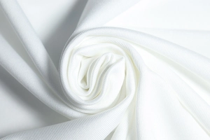 Macro shot of white honeycomb mesh fabric showing breathable texture and woven pattern