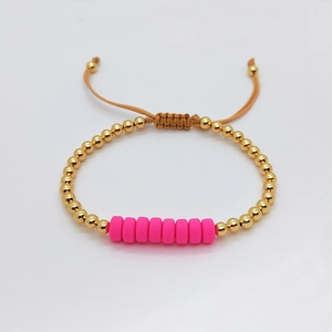 Ethnic pink clay bead and gold ball woven bracelet with adjustable cord for women