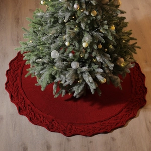 Red knit Christmas tree skirt with cable knit pattern for festive home holiday decoration