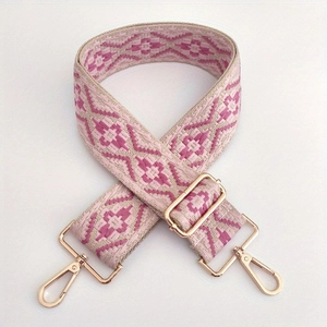 Close-up of pink ethnic jacquard weave bag strap with rose gold metal swivel carabiner hooks