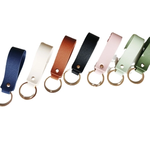 Leather keychain set with metal rings in various colors like navy, orange and green