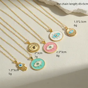 Gold Evil Eye and Hamsa Hand pendant necklaces set with enamel and rhinestones