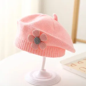 Close-up of pink knit beret for girls featuring a handmade 3D flower and ribbed texture