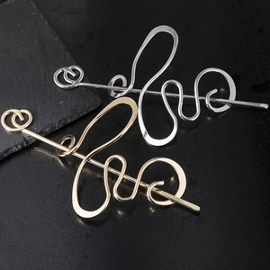 Abstract winding metal hair sticks in gold and silver finish with smooth glossy texture