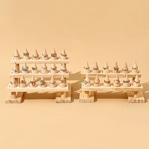 Multi-tier wooden ring display stand with cone holders for jewelry counter presentation