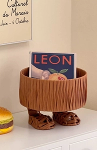 Creative foot-shaped woven basket detail with cute miniature sandals as home decor