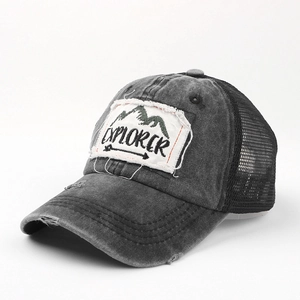 Detail of vintage washed grey trucker hat featuring Explorer embroidery and mesh back