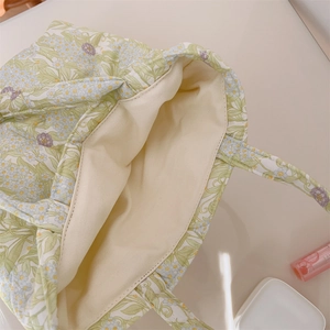 Detail of floral quilted canvas tote with thick inner lining and open top design