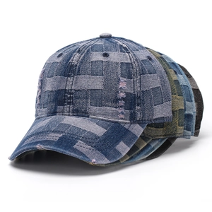 Detailed view of layered denim baseball caps with vintage distressed edges and textured fabric